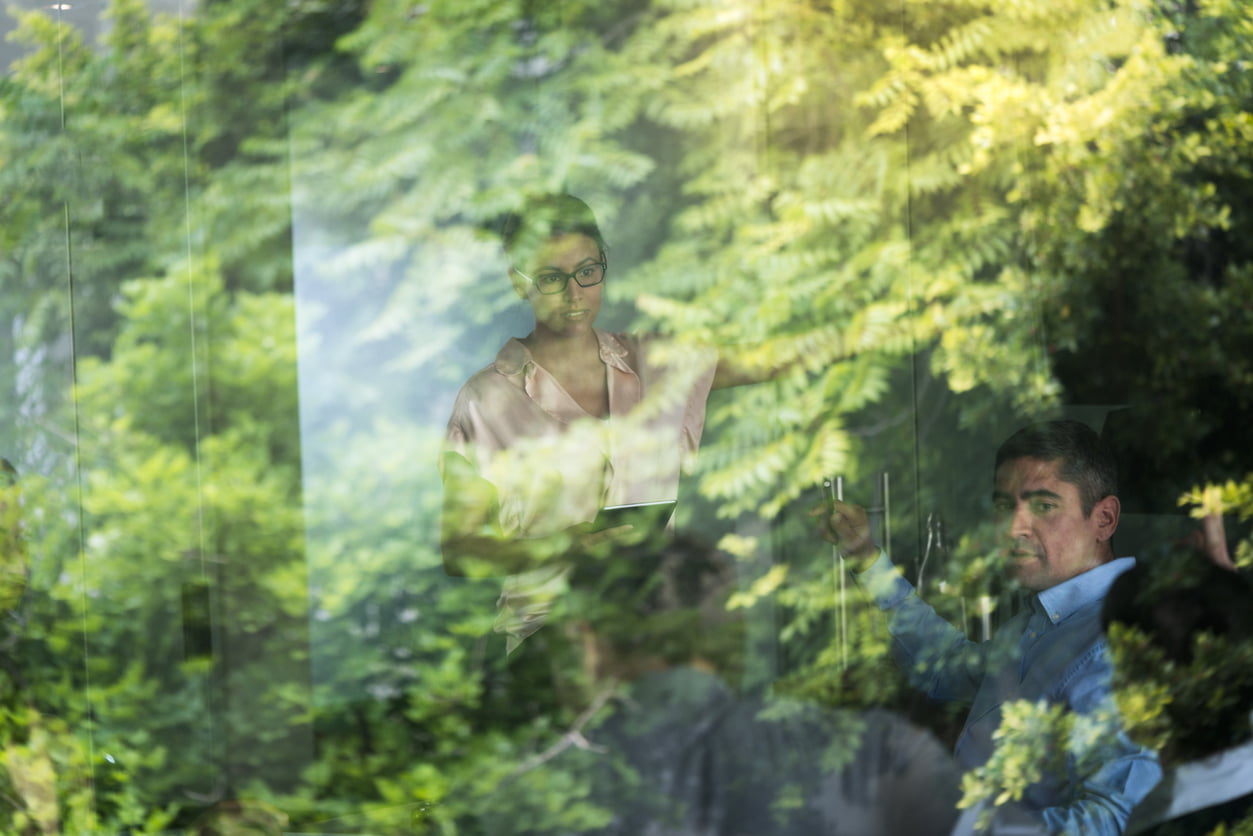 Business people seen through glass window