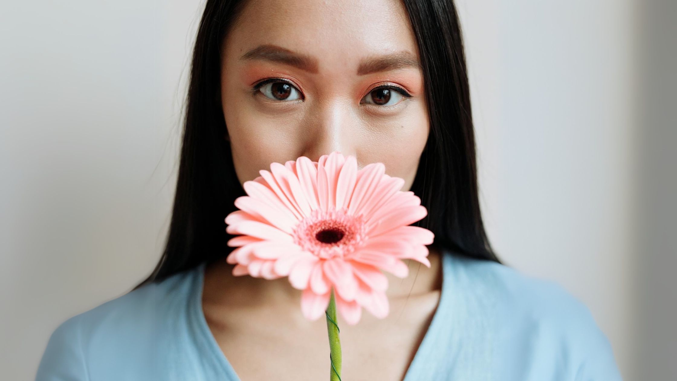 Greenhushing financial sector - woman with a flower covering her face